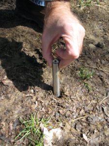 Gene Kritsky putting thermometer in the ground