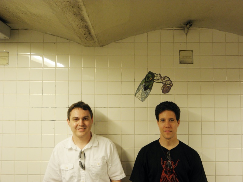 Roy Troutman and Elias Bonaros near cicada mosiac in subway